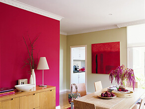 Dining room with a pink feature wall